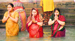 Women take a dip in the Ganga at Har-ki-Pauri on the occasion of Poornima in Haridwar on Thursday. 