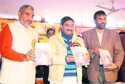 CM Ramesh Pokhriyal Nishank releases a souvenir of the Uttarakhand Forest Corporation in Dehradun on Thursday.