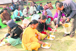 Members of the road construction and maintenance wing of the MC engineering department distribute langar at their Sector 38 office on the occasion of New Year celebrations on Friday.