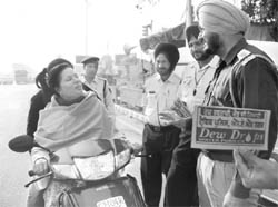 The police conducts an awareness campaign on traffic safety in Phase 7, Mohali, on Friday.