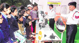 Cops explain the working of various equipment to children during the inauguration of the 21st National Road Safety Week at Children Traffic Park, Sector 23, Chandigarh, on Friday.