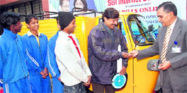 SK Sehgal, chief general manager of the State bank of India, donates a three-wheeler to The Theatre Age at Sector 17 in Chandigarh on Friday.