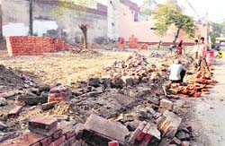 Construction of a wall at a park in Kidwai Nagar in progress while the work has yet to be allotted by the Ludhiana municipal corporation