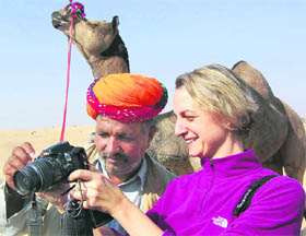 A foreign tourist shows a picture in her camera to a farmer during International Camel Festival in Bikaner on Friday.
