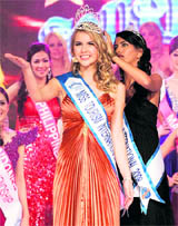 Sarah Elzanowski of Germany is crowned Miss Tourism International 2009 by last year's winner, Manasvi Mamgai of India, at a hotel in Petaling Jaya, Malaysia, on Thursday.