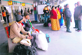 Passengers wait for a train at the Chandigarh railway station on Saturday. 