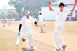 Batsmen scramble for a run during a match at the 58th District Cricket League in Dehradun