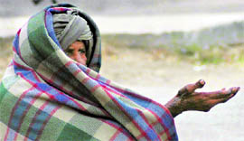 Braving chilly weather, an old man begs for alms in Karnal on Saturday.