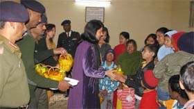 Reema Jagga, president of AWWA Black Arrow Brigade gives gifts to special children during a healthcare camp