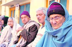 Inmates of an old age home wait for their children to visit them for New Year celebrations at Amphalla in Jammu