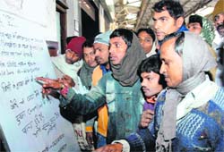 People read the information bulletin at Patna junction on Saturday regarding the Lichchavi Express-Magadh Express collision at Saraibhopat near Etawah.