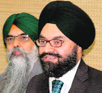 Barrister-cum-Solicitor Gurpal Singh of Melbourne makes a point while Navkiran Singh looks on at an interaction with a select group of newsmen in Chandigarh on Saturday. 