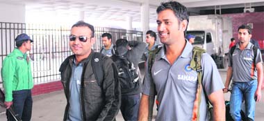 Indian cricketers Virender Sehwag (L) and M S Dhoni (R) after arriving at the Zia International Airport in Dhaka on Saturday.