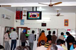 visitors (below) get token numbers for various works