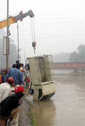 A team of Sahara Jan Sewa workers lifting out a tempo which fell into the Sirhind canal on the Santpura road in Bathinda on Sunday.