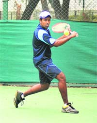 A player in action during the Grade-3 ITF Tennis Tournament at the Chandigarh Lawn Tennis Association in Chandigarh