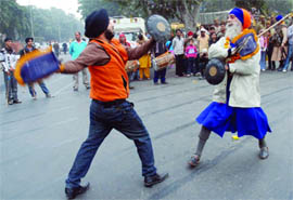 Devotees perform gatka during Nagar Kirtan.