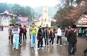 Youngsters enjoy a walk on the Ridge even as temperature plummeted after a rain in Shimla
