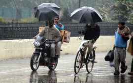 Rains add to the miseries of the commuters, already affected by dense fog and cold weather, in Jalandhar on Sunday.