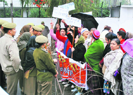 Activists of the Mahila Sanrakshan Samiti protest in Jammu on Sunday.