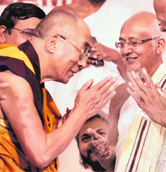 Tibetan spiritual leader Dalai Lama seeks blessings from a Jain saint in Palitana, a pligrimage centre in Gujarat, on Sunday.