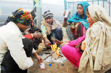 As the temperature in Amritsar hovers around sub-zero, people warm themselves up near a bonfire on Sunday.