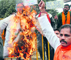 Members of the Shiv Sena burn an effigy of Union Agriculture and Food Minister Sharad Pawar during a protest against rise in the prices of essential commodities in Amritsar on Sunday.