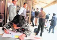 A girl paints to pass time after flights were delayed at the Chandigarh airport 