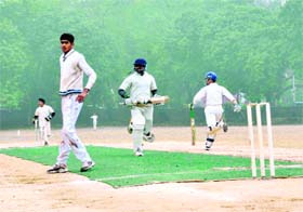 Batsmen cross over for a run during a match at the Banke Lal Shah Memorial Cricket Tournament in Dehradun