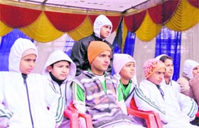 A group of cricketers feel the chill on the sidelines of a match