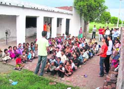 A group of university and school students teach poor children in Sonepat