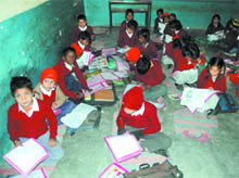 Students of Government Senior Secondary School, Ladowali Road, sit on the floor on Monday. 