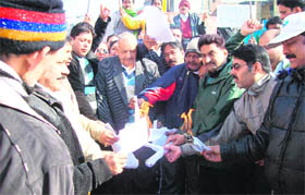 BJP leaders and workers burn copies of the Working Groups report on Centre-state relations in Jammu on Monday.