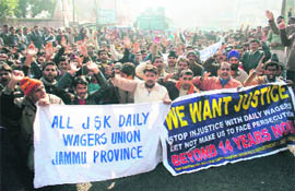 Daily wage PDD employees hold a rally in Jammu on Monday.