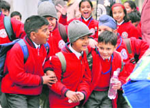 Braving severe cold, students attend their classes as numerous city schools opened in defiance of the DCs order in Ludhiana on Monday.