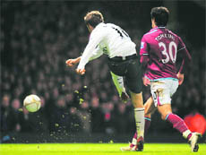 Arsenals Aaron Ramsey scores against West ham in London on Sunday.