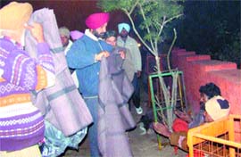 Deputy Commissioner Kahan Singh Pannu distributes blankets among poor people in Amritsar