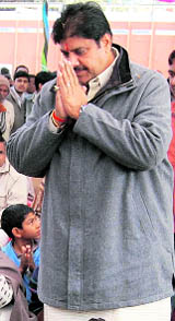 Ajay Singh Chautala, secretary general of the INLD, greets people at a public meeting in Kagdana village on Tuesday.