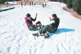 A couple throws snowballs at each other at Kufri