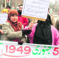 Activists of the Muslim Khwateen Markaz hold a protest in Srinagar on Tuesday.