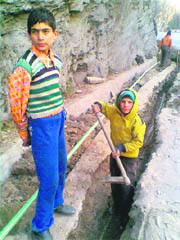 Child labourers work on a digging site in Banihal, cocking a snook at anti-child labour laws.