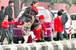 Parents escort their children back home from Sacred Heart Convent, Sarabha Nagar, in Ludhiana