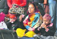 Stranded passengers sip tea to beat the chill at the Ludhiana railway station.