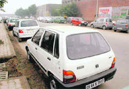 The road leading to Sector 48-C and in front of the motor market is crowded with cars needing repairs and mechanics carry out their work at the parking lot adjoining the motor market.