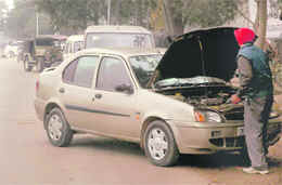 The road leading to Sector 48-C and in front of the motor market is crowded with cars needing repairs and mechanics carry out their work at the parking lot adjoining the motor market.