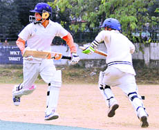    Batsmen cross over for a run at the Banke Lal Shah Memorial Cricket Tournament in Dehradun on Wednesday.