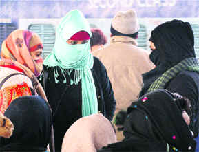 Girls protect themselves against chill in Faridabad on Wednesday.