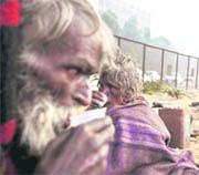 A homeless man sips tea on a chilly morning in New Delhi on Wednesday.