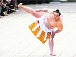 Mongolian-born grand sumo champion Yokozuna Asashoryu, wearing a ceremonial belly band, performs a ring-entering ritual at Meiji Shrine in Tokyo