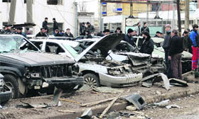 Locals stand near the site of bomb explosion at a special traffic police depot in Russias southern city of Makhachkala on Wednesday.